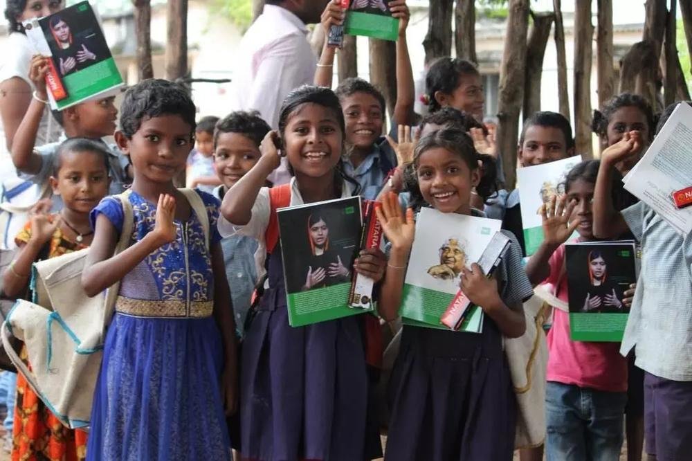Children holding books at a literacy programme